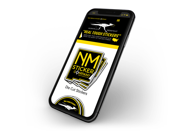 Image of cell phone that is displaying New Mexico Sticker Company website on the screen.